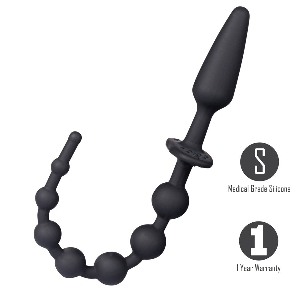 Black silicone anal plug and bead strand with a dual use flared base laid out on a neutral background.